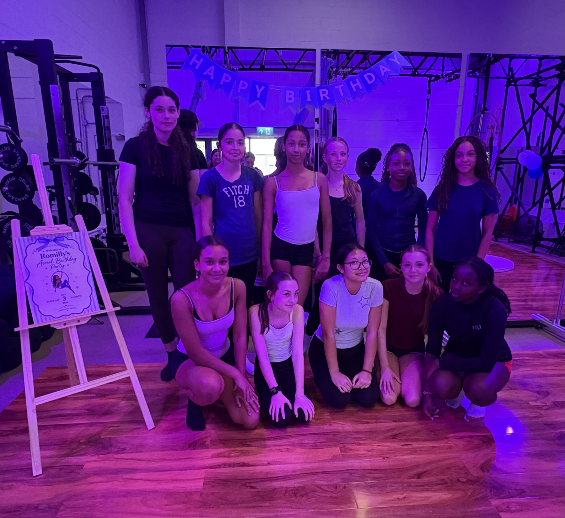 Friends celebrating an aerial birthday party together in the studio
