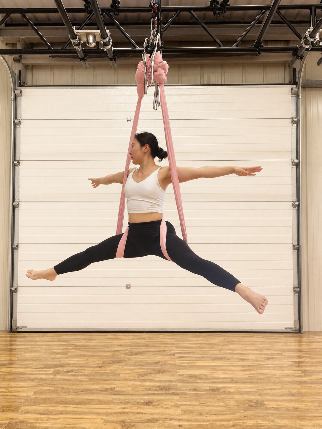 Supported Aerial Yoga inversion using a pink hammock at Vertical Muse