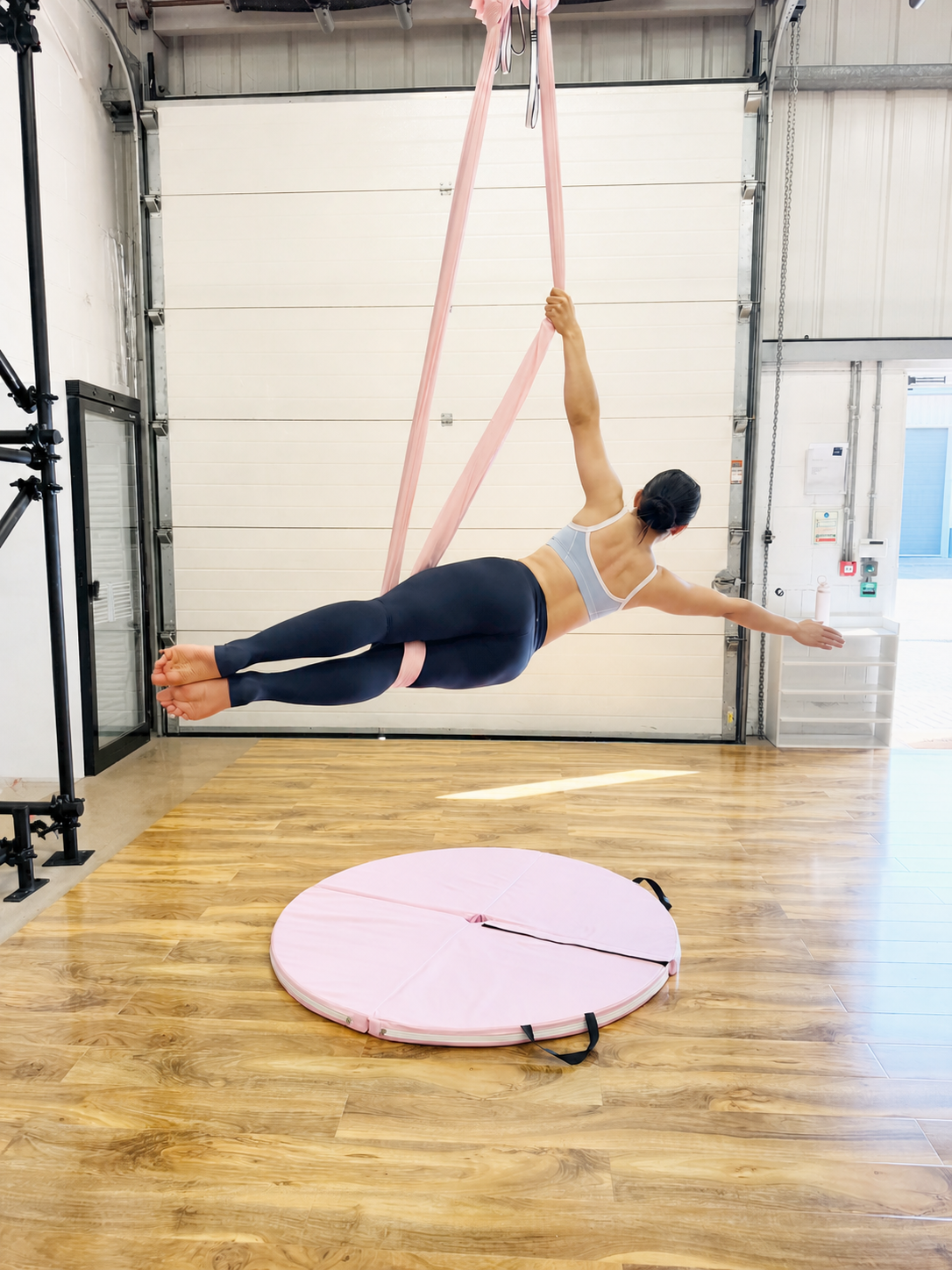 Aerial hammock student practising a flying pose at Vertical Muse