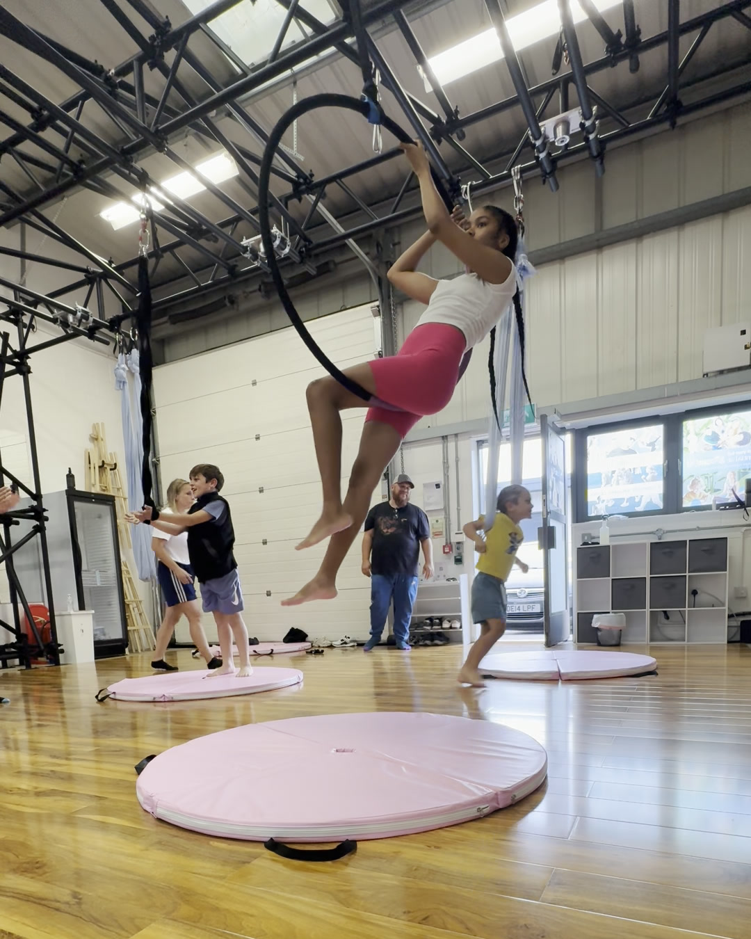 Junior aerial student practising a seated hoop shape